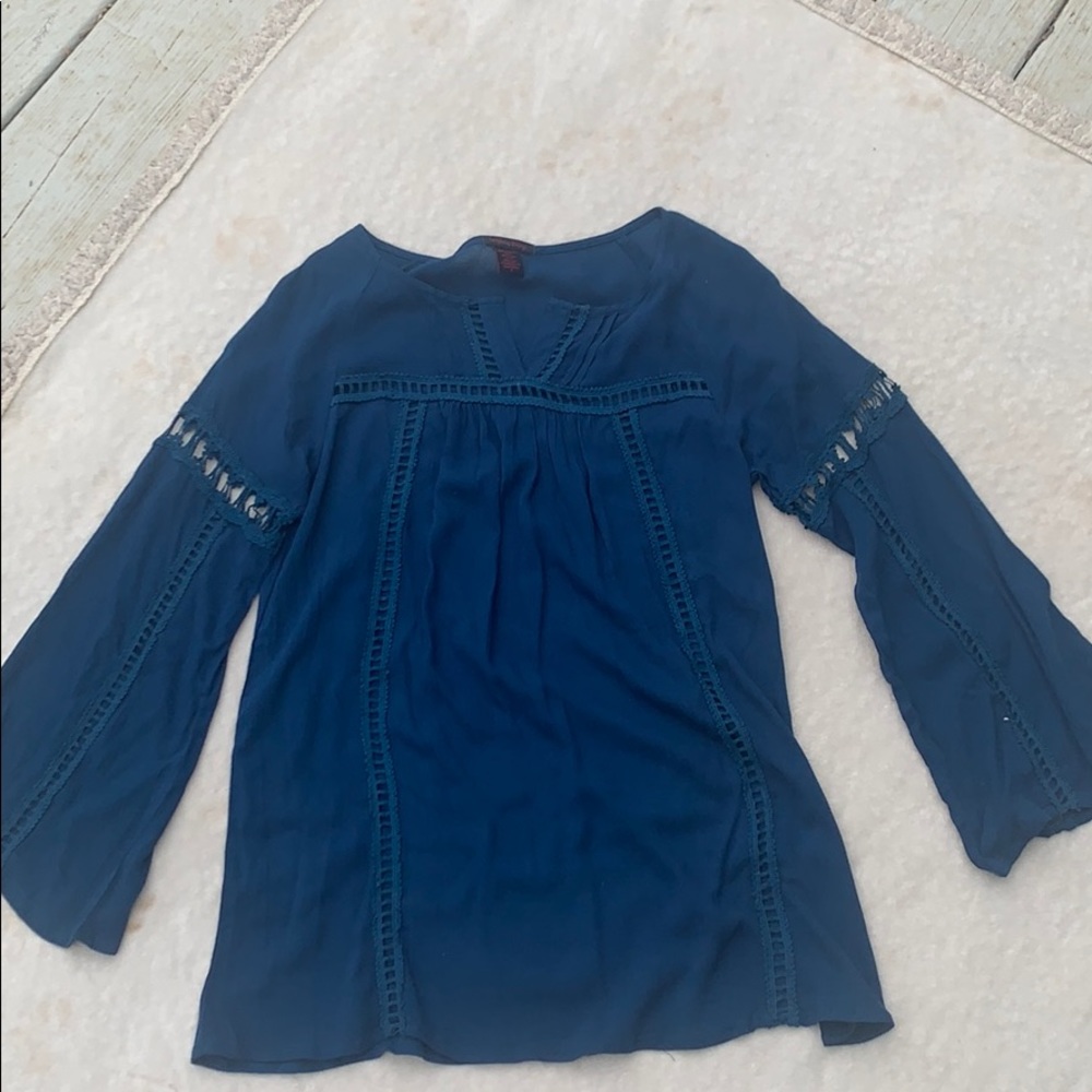 Blue top with stitch design.
